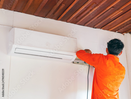 Air conditioning technicians install new air conditioner in homes.