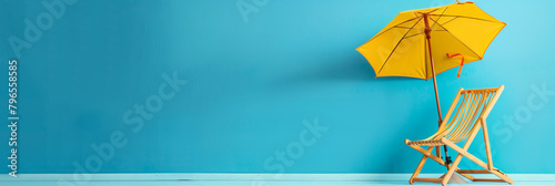 Beach chair and umbrella on blue wall background with copy space #796558585