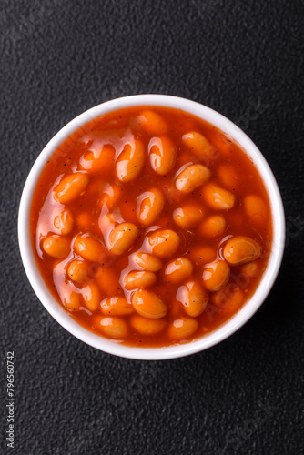Delicious nutritious canned beans in tomato, with salt and spices