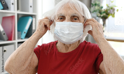 Elderly Woman Puts On Protective Medical Mask On Face
