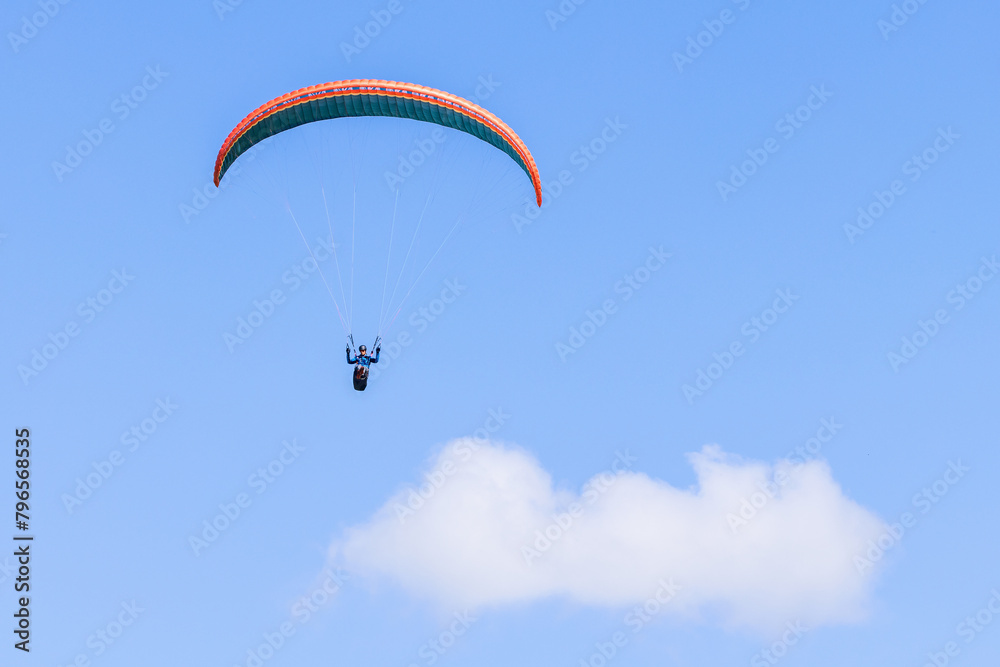 Alone Paraglider flying above the clouds Alone Paraglider flying above the clouds