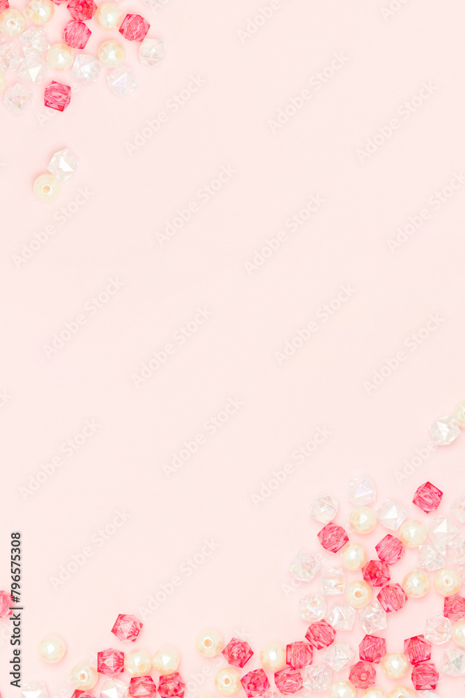 Shiny acrylic beads on a pink background with copy space. Shiny acrylic beads on a pink background with copy space.