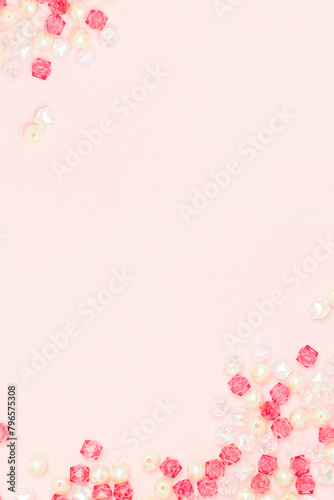 Shiny acrylic beads on a pink background with copy space. © rorygezfresh