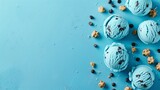 Top view of blue bubble gum ice cream scoops with scattered toppings on blue background