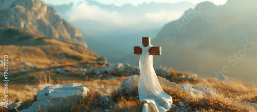 Picturesque landscape of an old wooden cross with a scarf of white fabric against a backdrop of mountains and blue sky. Faith, Orthodoxy, symbol of hope. photo