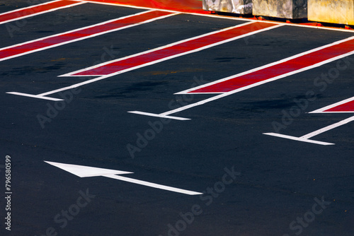 Red and white arrows on a parking lot in the city. Road marking at parking