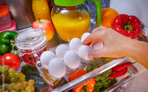 Chicken eggs on a shelf open refrigerator © Andrei Armiagov