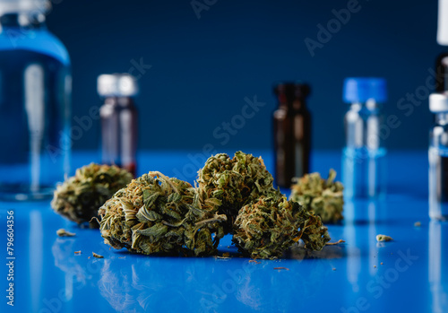 cannabis buds and laboratory flasks
