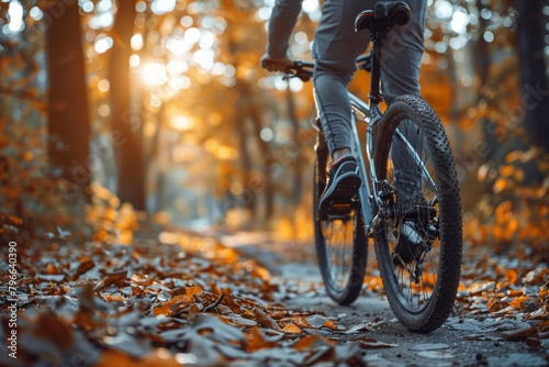 A cyclist swiftly rides through a leaf-strewn path in a forest, surrounded by the beauty of fall