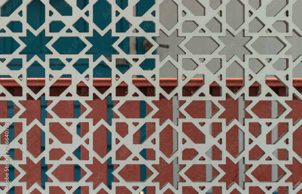 Delicate carved wooden with Traditional geometric patterns decorating a wall in Bang O Mosque. Space for text, Selective focus. Delicate carved wooden with Traditional geometric patterns decorating a wall in Bang O Mosque. Space for text, Selective focus.