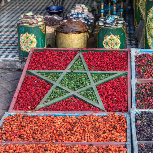 Aromatic spices on display, in the shape of the Moroccan flag, outside a shop in the souk of Marrakech, Morocco © parkerspics