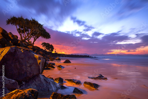 Incredible colourful sunset at Byron Bay over the water photo