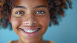 close up portrait of smiling young black woman with braces or brackets on her teeth, orthodonsis treatment, oral care