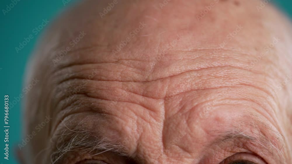 Close-up of wrinkled forehead and gray eyebrows of elderly man Close-up of wrinkled forehead and gray eyebrows of elderly man