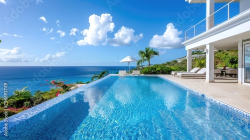 A large pool with a white umbrella and a view of the ocean