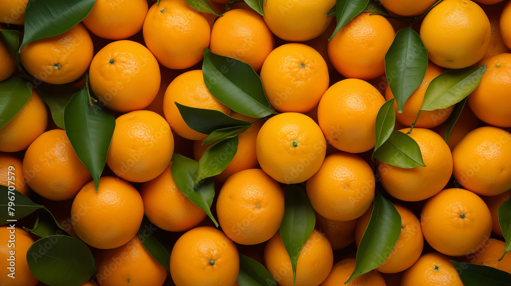 Pile of oranges with leaves stacked on top of each other top view