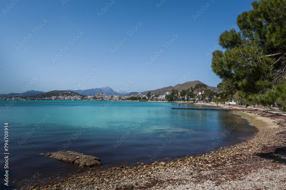 Pollenca, Mallorca, Balearic Islands, Spain. Beautiful little  rocky beach, turquoise Mediterranean sea, blue sky. 