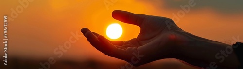A photo of a hand holding a glowing crystal ball at sunset
