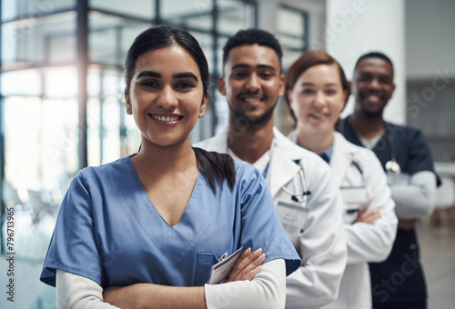 Doctors, woman and arms crossed with smile, team or portrait for diversity in medical career at hospital. Surgeon group, people and men with collaboration, wellness and pride for healthcare services photo