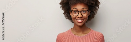 Close-up photo of a smiling African American woman with eyeglasses against a white background, styled as a banner