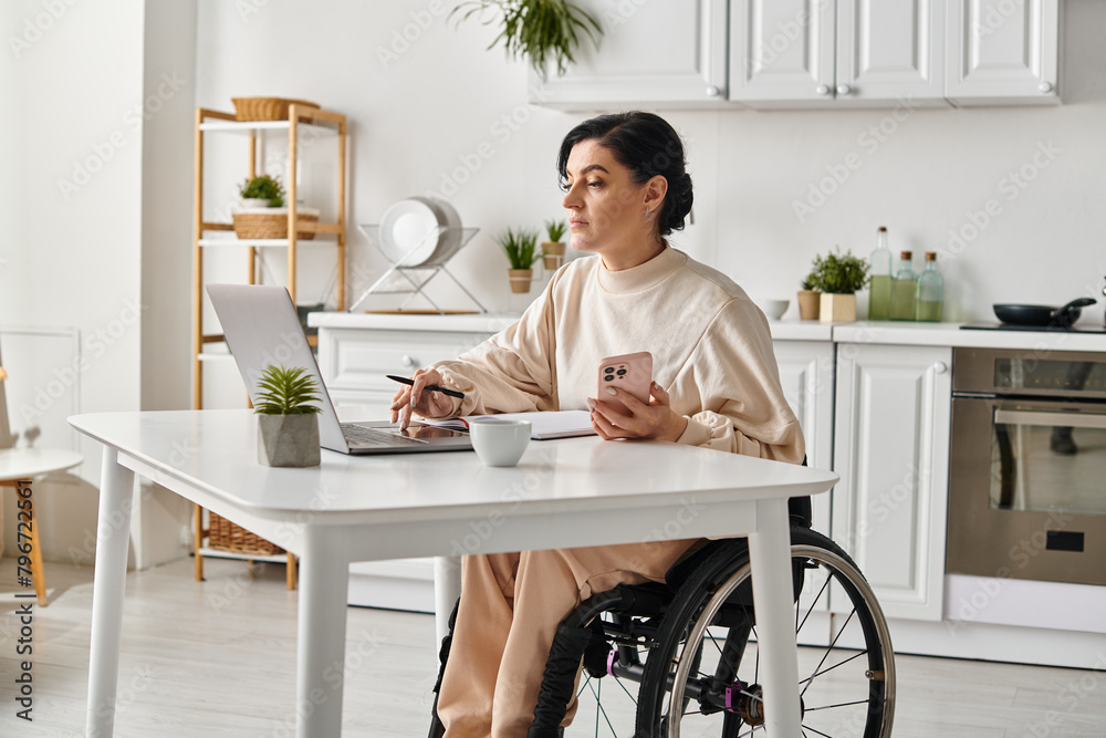 A disabled woman in a wheelchair utilizing a laptop at home in her kitchen for remote work. A disabled woman in a wheelchair utilizing a laptop at home in her kitchen for remote work.