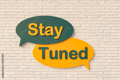 Stay tuned. Cartoon speech bubble in yellow and dark green, brick wall. Keep watching, keep listening, informed, briefed, mindful, perfection, connected, be in touch. 3D illustration