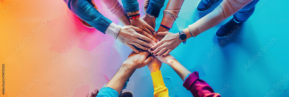 person holding hands with a group of people standing in front of a blue wall, with one person's blu