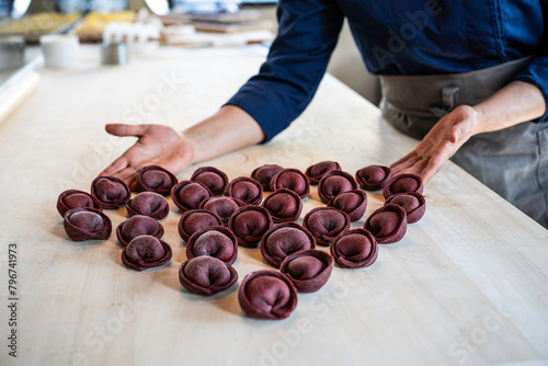 Artisanal beetroot tortelli arranged with love, a culinary heart in Italian cuisine. A chef's touch brings a gourmet creation to life, crafting with passion and precision. photo