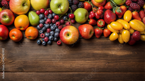 Top view of fresh fruits, vegetables and berries on wood floor background