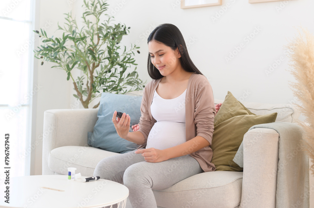 Pregnant woman checking blood sugar level by using Digital Glucose meter, health care, medicine, diabetes, glycemia concept