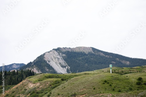 Picturesque Mountain Range In A Rural Area With A Tower On The Top photo