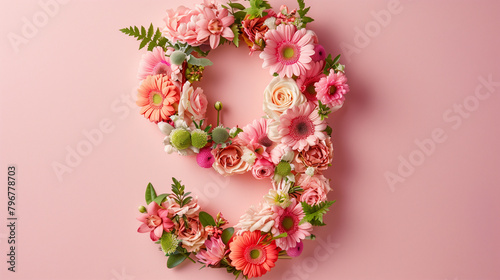 Top View Pink Floral Number Nine. Top view of number 9 floral arrangement on pink background for celebrations.
