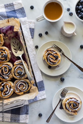 Servings of homemade blueberry cinnamon buns, served with tea.