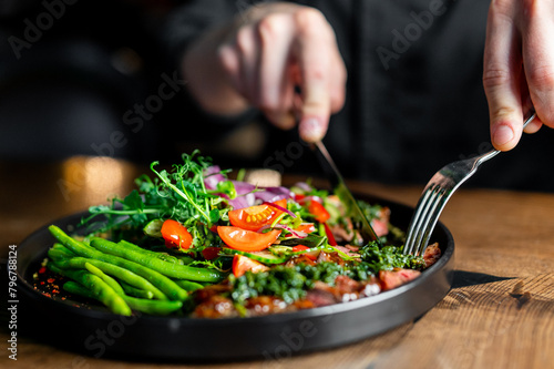 Person indulging in a vibrant, fresh salad, showcasing the allure of healthy eating