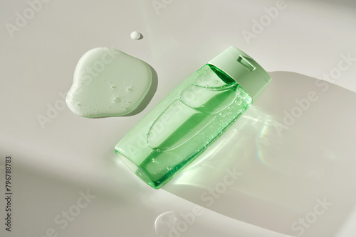 Shower gel or shampoo on a white background with sun light.