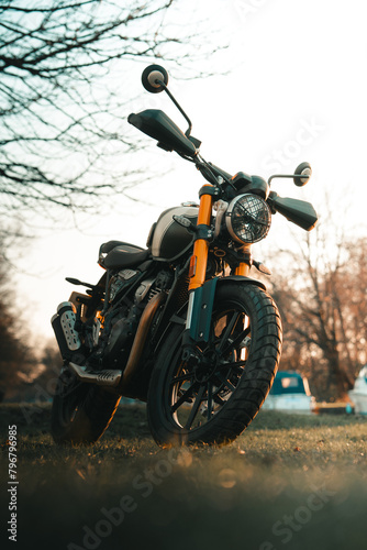 Scrambler motorcycle at sunset, cafe racer style retro motorbike wallpaper © Adam Rhodes