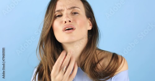 Unhappy girl looking in the mirror, checking dry irritated skin. Skincare routine, skin problem. Beautiful girl with not smooth skin crushes acne on her face, she sad about it, not like.