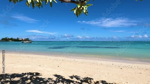 4K Turquoise blue ocean under tropical trees. A boat parked in the sea. mauritius pereybere coast  (ID: 796803723)
