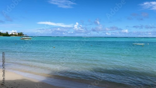 K Magnificent crystal waters hitting the beach accompanied by ocean waves from Pereybere Villa beach in Mauritius. (ID: 796803939)