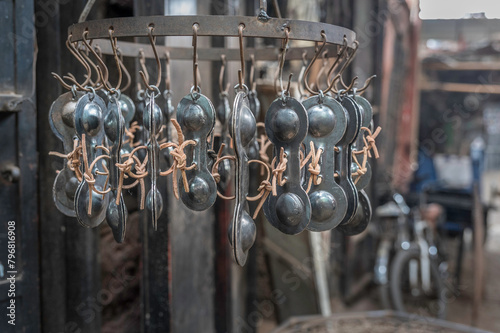 Moroccan metal Castenets, hanging outside a metal workshop in the heart of the Marrakesh souq © parkerspics