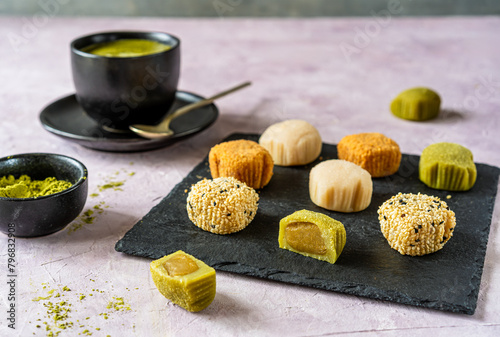 Variety of Mochi on Slate with Matcha Tea Side View