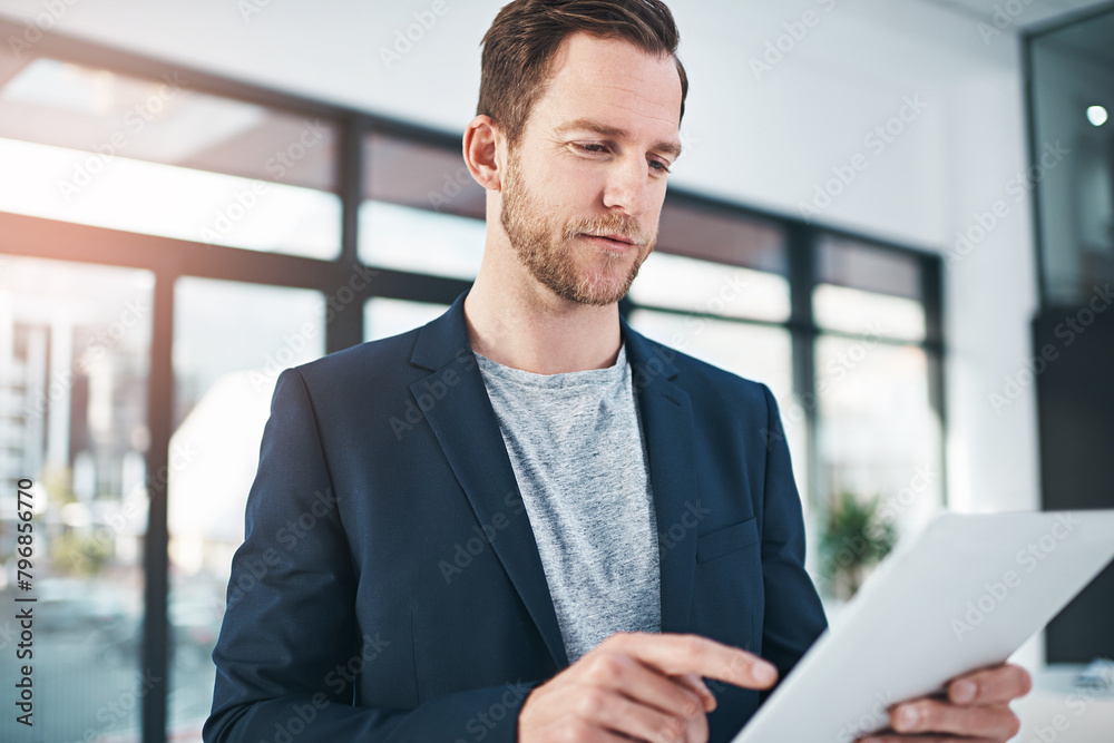 Fototapeta premium Businessman, tablet and internet research as tech startup or project planning or game design, digital app or office. Male person, scrolling and finger or programming software, entrepreneur or contact