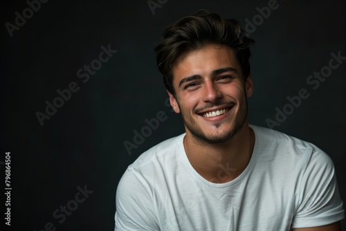 Handsome young man in white t shirt  studio portrait.