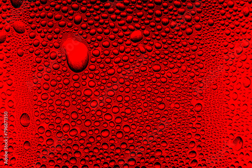 Red close-up macro drink water drop surface,Water droplets on a glass of red cold drink for background and texture. (close up, selective focus, space for text)