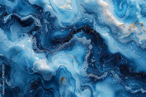 The stunning abstract features the swirling dance of blue currents accented with white and gold photo