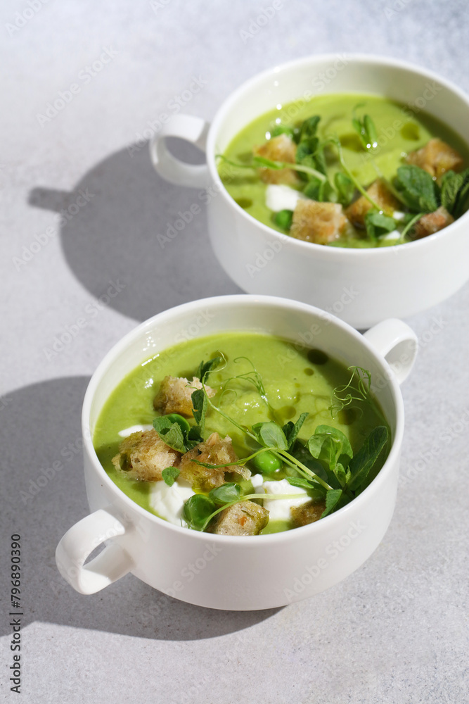 Cool Summer Pea Soup with Croutons, Sour Cream, Fresh Mint, Pea Sprouts, and Parsley Green Oil. Vegetarian Cuisine Idea. Artisanal Photography, Not AI Cool Summer Pea Soup with Croutons, Sour Cream, Fresh Mint, Pea Sprouts, and Parsley Green Oil. Vegetarian Cuisine Idea. Artisanal Photography, Not AI