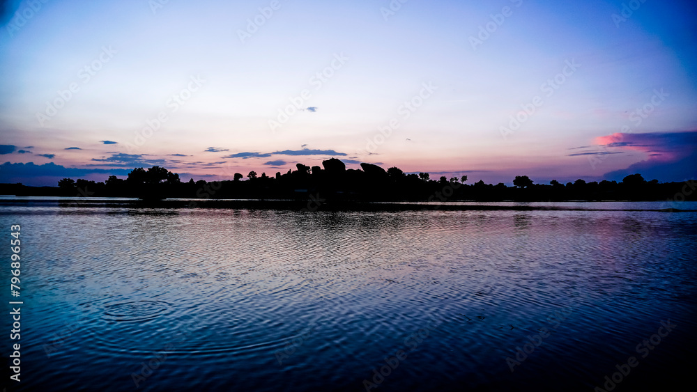 panoramic against the light of dawn in the lagoons of Los Barruecos with large granite masses
