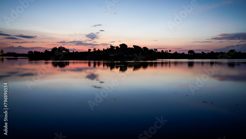 panoramic against the light of dawn in the lagoons of Los Barruecos with large granite masses photo