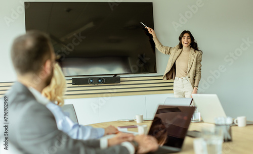 Confident businesswoman leading a strategic planning session in a modern office