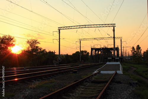Railway in the rays of the setting sun
